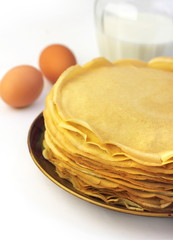 Stack of thin pancakes on a plate