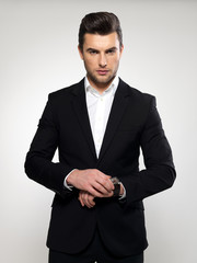 Fashion young businessman in black suit