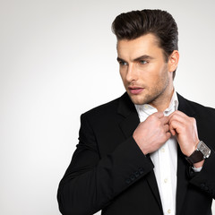 Fashion young businessman in black suit