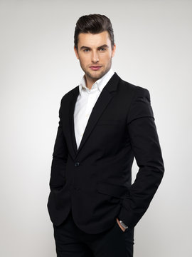 Fashion young businessman in black suit