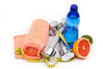 fitness dumbbells  and fruits isolated on white