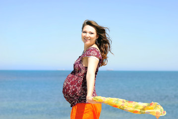 beautiful pregnant with a girl by the sea