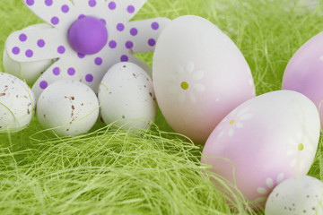 Easter Eggs sitting on grass and Flower