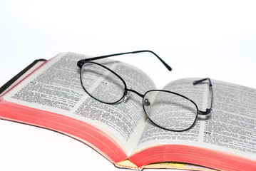 Bible with a pair of glasses