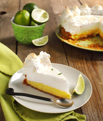 Slice of Key lime pie with fresh limes