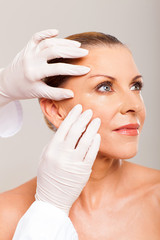 skin check on mid age woman face © michaeljung