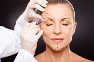 middle aged woman preparing for plastic surgery - obrazy, fototapety, plakaty