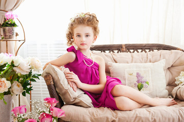 Fototapeta premium Little girl lying on the sofa
