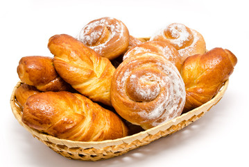 Group of delicious cinnamon rolls in basket isolated
