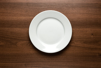 White empty plate at the table with copy space