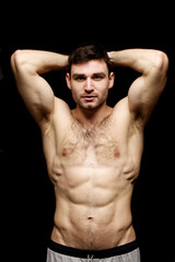 Fototapeta premium Topless man stood on a black background
