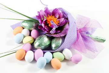 Colorful Easter Eggs with flowers and chocolate eggs