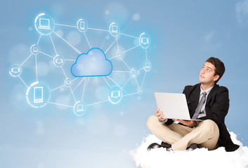 Happy businessman sitting on cloud with cloud computing