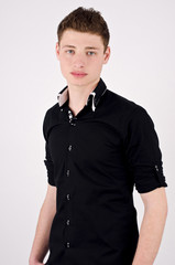 Fototapeta premium Young attractive stylish man in black shirt standing.