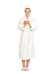 Full length portrait of young woman in bathrobe holding cup