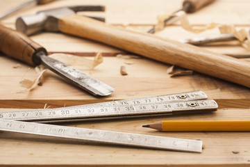 carpenter tools,hammer,meter and chisel  over wood table