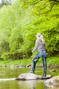 woman fishing in Sazava river, Czech Republic