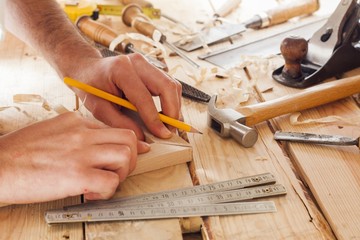 carpenter working,hammer and meter  on construction background