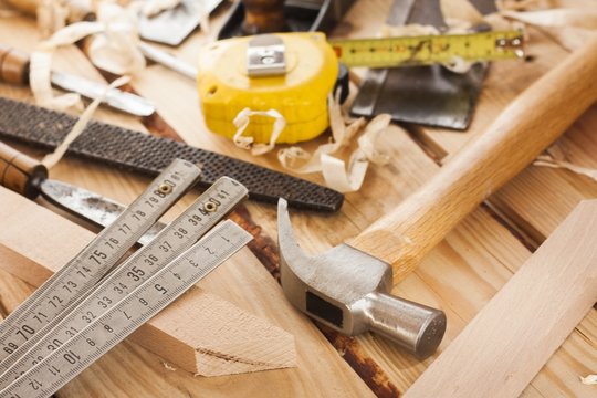 carpenter tools,hammer,meter,nails, and chisel over wood table