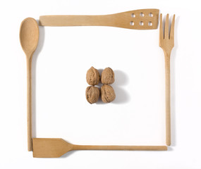 Four Wooden Kitchen Tools and Four Walnuts