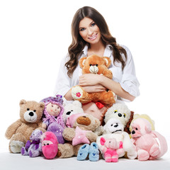 Beautiful happy pregnant woman with plush toys