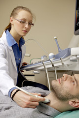 Fototapeta premium Portrait of young female technician operating ultrasound machine
