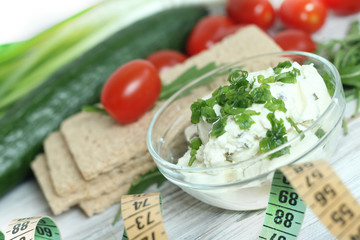 Fresh cream cheese spread in small bowl with chives on top 