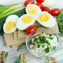 Fresh cream cheese spread in small bowl with chives on top 