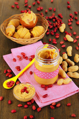 Delicious peanut butter in jar with baking