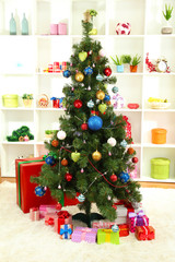 Decorated Christmas tree on home interior background