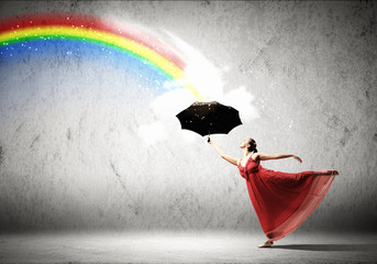 Ballet dancer in flying silk dress with umbrella