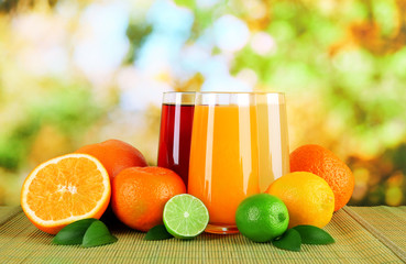 Glasses of juise with leafs and fruits