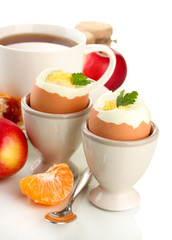 Light breakfast with boiled eggs and cup of coffee, isolated
