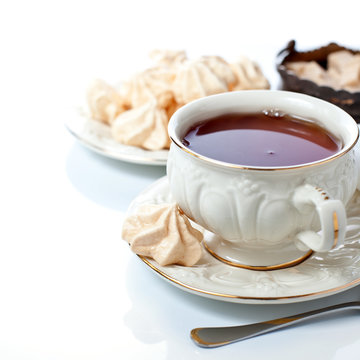 Elegant tea cup and freah meringues