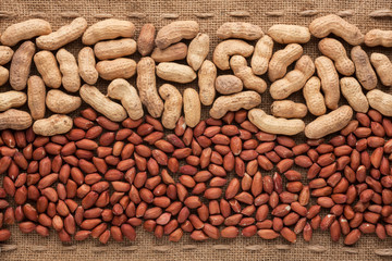 Shelled and unshelled peanuts lying on sackcloth
