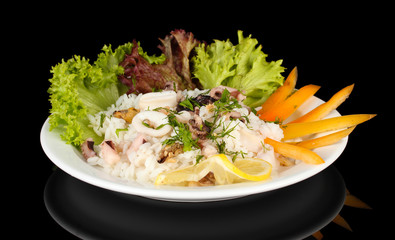 Delicatessen seafood salad with rice isolated on black