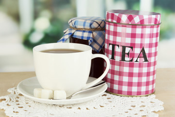 Jar and cup of tea isolated on white