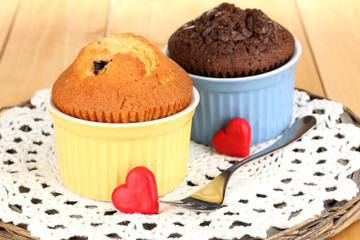 Cupcakes in bowls for baking on wooden table