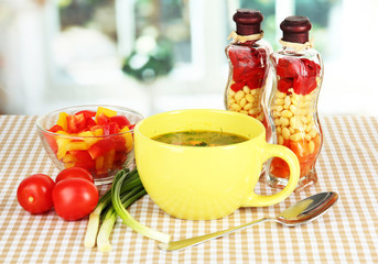 Fragrant soup in cup on table in kitchen