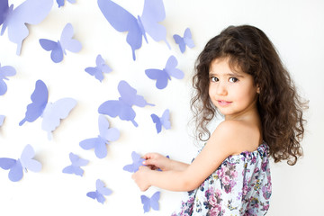 The girl against a wall decorated with butterfly