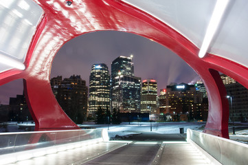 Calgary skyline and peace bridge at night.
