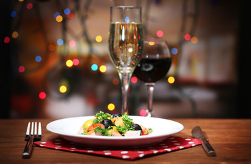 Tasty salad on dark background with bokeh  defocused lights