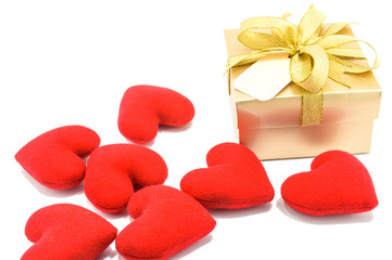 Golden gift box and red heart on white background.