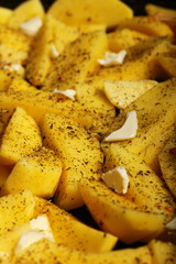Raw potatoes with spices ready to be roasted
