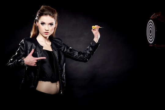 punk girl with dart and target black background