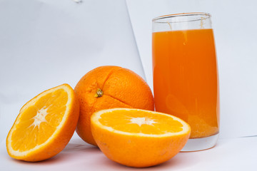 glass of orange juice on white