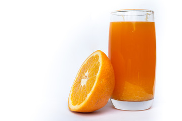 Glass with orange juice and oranges isolated