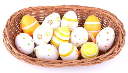Easter eggs in basket isolated on white background