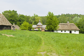 Fototapeta na wymiar Pirogovo, village house and wooden church