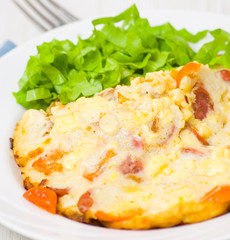 scrambled eggs with smoked sausage, cheese and cherry tomatoes